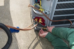 this image is about servicing an air conditioning unit