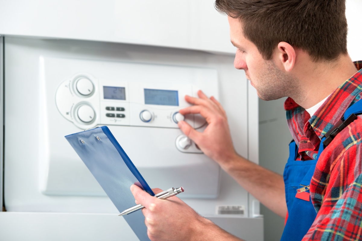 Technician servicing heating boiler